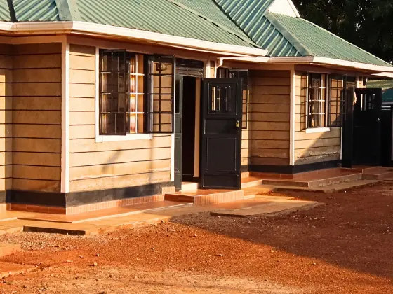 Front of a bungalow with a window and an open black door